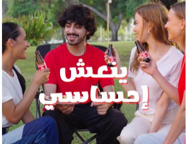 Group of friends enjoying Oronamin C drinks during an outdoor lifestyle shoot in a Dubai park