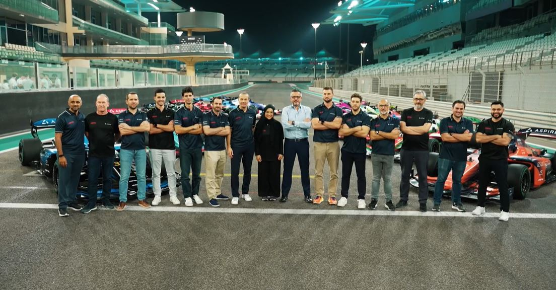 A2RL Engineering Team Autonomous Racing Group A2RL Engineering Team standing on the racetrack with autonomous race cars, highlighting collaboration, innovation, and advanced motorsport engineering.