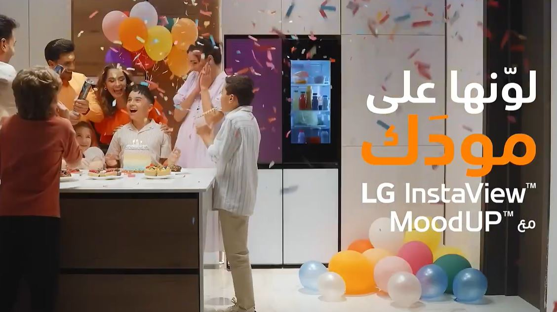 lg-moodup-cinematic-story-dubai.webp Family celebrating in a modern kitchen as LG MoodUp refrigerator lights up the space, showcasing smart design, color panels, and lifestyle living.