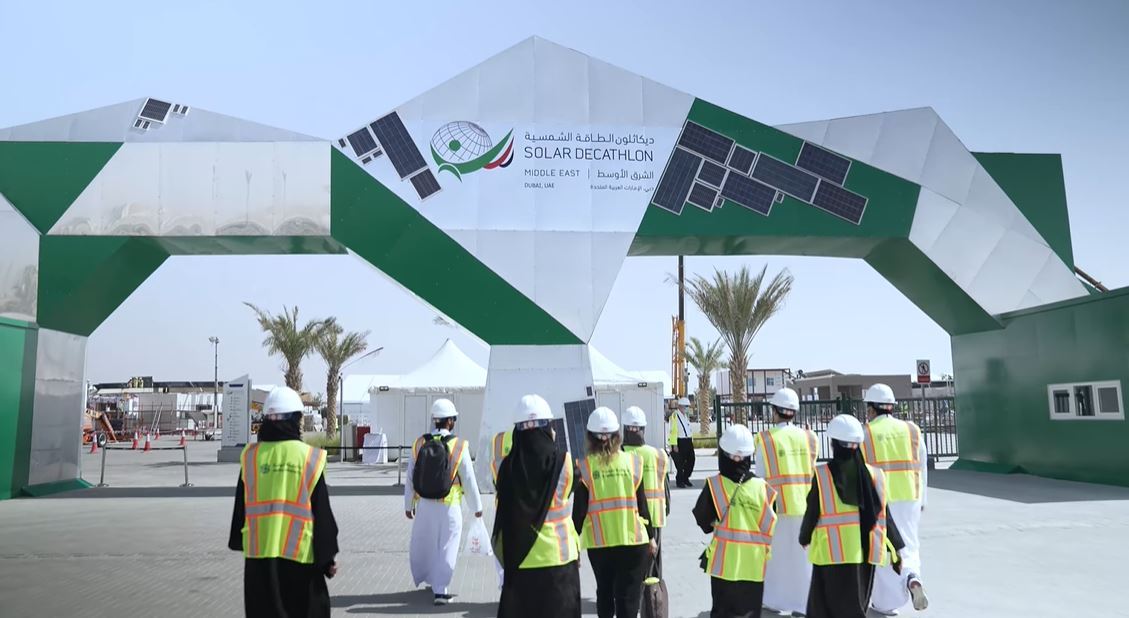 solar-decathlon-middle-east-2021.webp Teams enter the Solar Decathlon Middle East site, showcasing sustainable housing innovation, smart design, and global collaboration in Dubai.