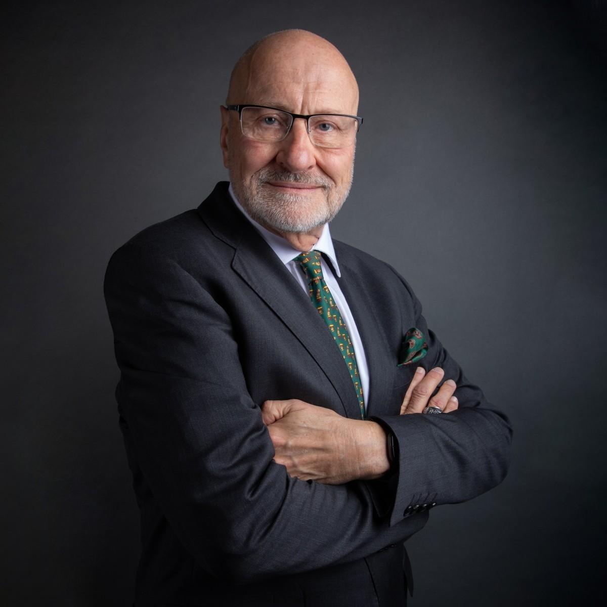 Corporate Headshot Photography for Executives Professional corporate portrait of a confident senior executive in a suit, showcasing refined business headshot photography with studio lighting.