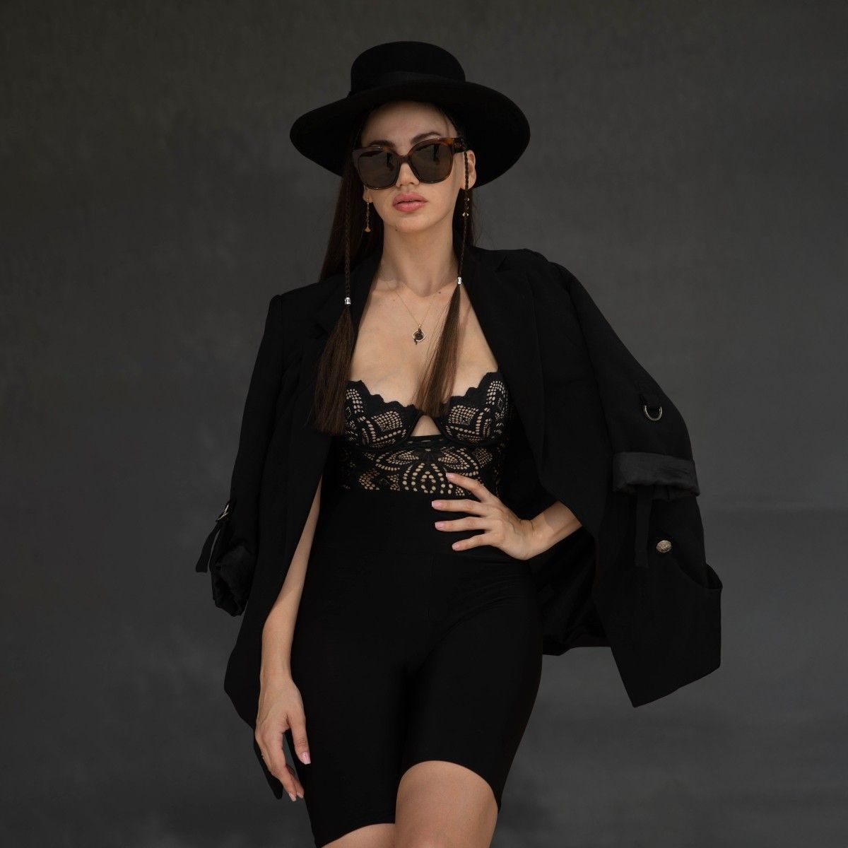 Creative Portrait Photography Services with Bold Studio Styling Elegant studio portrait of a confident woman in black fashion styling, showcasing creative portrait photography services with dramatic lighting and bold expression