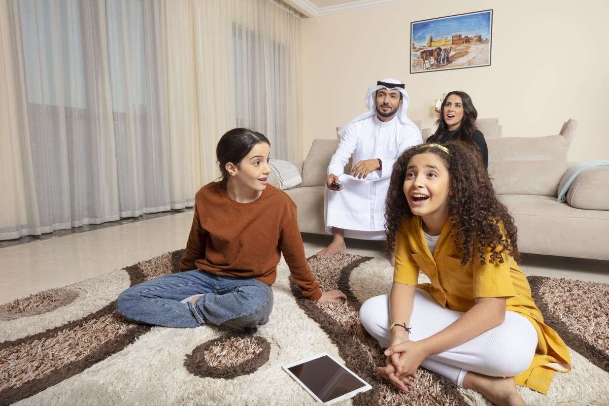 Arab family enjoying entertainment together at home, capturing joyful lifestyle moments through professional commercial video production