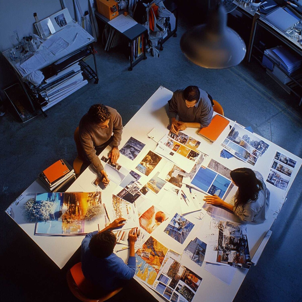 Strategic media planning services team reviewing visual assets and campaign concepts to build data-driven content strategies for brands