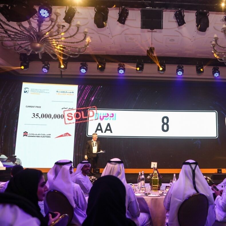 Event Production and Photography Services capturing a live auction event with stage lighting and engaged audience coverage