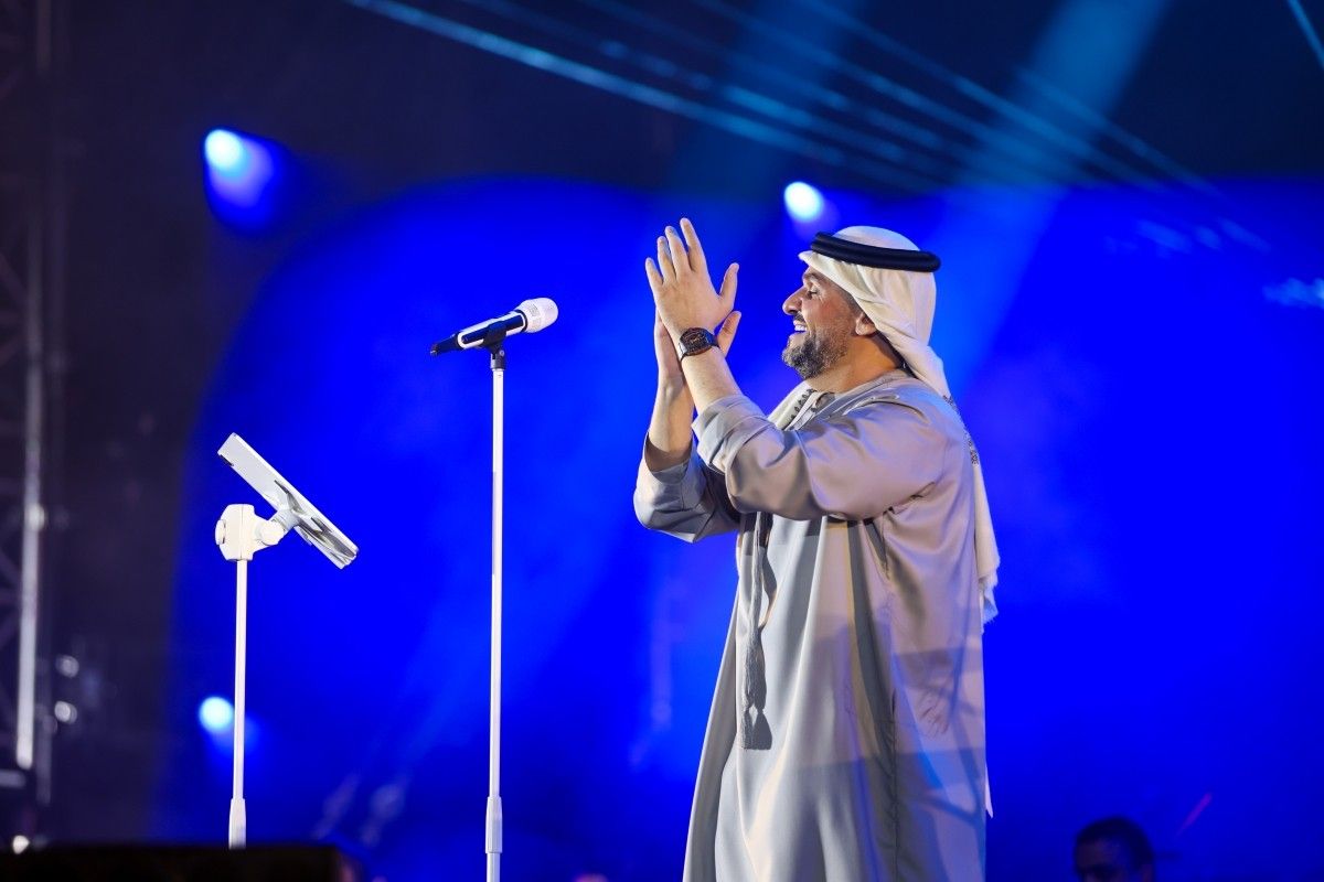 Professional Event Production & Photography Coverage Event Production and Photography Services capturing a keynote speaker on stage with cinematic lighting and professional event coverage